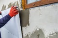 Construction worker installing styrofoam insulation sheets on house facade wall for thermal protection Royalty Free Stock Photo