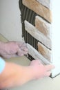 Construction worker installing tiles on a wall Royalty Free Stock Photo
