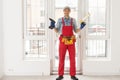 Construction worker installing window in house. Handyman fixing the window with screwdriver Royalty Free Stock Photo