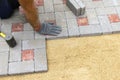 A construction worker installs concrete blocks for sidewalks in the courtyard of a country house Royalty Free Stock Photo