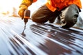 Roofer Using Power Drill on Metal Sheet Roof Royalty Free Stock Photo
