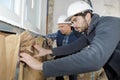 Construction worker insulating house walls