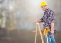 Construction Worker on ladder in front of construction site Royalty Free Stock Photo