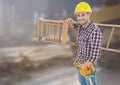 Construction Worker with ladder in front of construction site Royalty Free Stock Photo