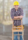 Construction Worker on ladder in front of construction site Royalty Free Stock Photo