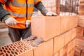 Construction worker laying bricks on exterior walls Royalty Free Stock Photo