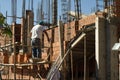 Construction worker laying bricks on new house