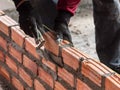 A construction worker laying bricks showing trowel and guideline Royalty Free Stock Photo