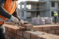 Construction worker laying bricks with a trowel at a building site Royalty Free Stock Photo