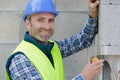 construction worker laying bricks and using measuring tape Royalty Free Stock Photo