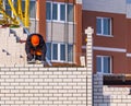 Construction Worker Laying Bricks and wearing an orange hard hat. Royalty Free Stock Photo