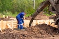 Construction worker laying cement or concrete into the foundation formwork Royalty Free Stock Photo