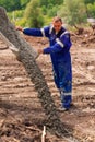 Construction worker laying cement or concrete into the foundation formwork Royalty Free Stock Photo