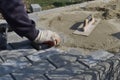 Construction worker are laying concrete pavement stone for footpath work at the construction site. Paving stone worker is putting Royalty Free Stock Photo