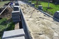 Construction worker are laying concrete pavement stone for footpath work at the construction site. Paving stone worker is putting Royalty Free Stock Photo