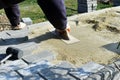 Construction worker are laying concrete pavement stone for footpath work at the construction site. Paving stone worker is putting Royalty Free Stock Photo