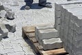 Construction worker laying concrete tiles to pave street