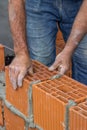 Construction worker laying hollow clay block Royalty Free Stock Photo