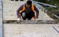 Construction worker laying interlocking paving concrete Royalty Free Stock Photo