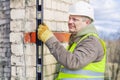 Construction worker with level near wall Royalty Free Stock Photo