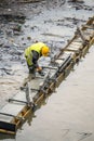 Construction worker leveling concrete formwork 2