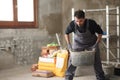 Construction worker lifting carricot in a house Royalty Free Stock Photo