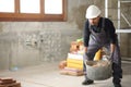 Construction worker lifting a heavy carrycot Royalty Free Stock Photo