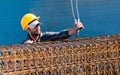 Construction worker loading beam cages