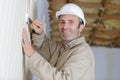 construction worker with long trowel plastering wall Royalty Free Stock Photo