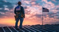 Construction worker looking at american flag on building site at sunset Royalty Free Stock Photo
