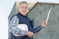 construction worker looking on clipboard outdoors Royalty Free Stock Photo