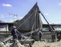 Construction worker man team working piling equipment. Building house by use three legs crane. Install steel structure.