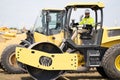 construction worker man used heavy machinery road roller equipment on building industry site for roadwork outdoor Royalty Free Stock Photo