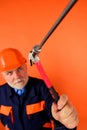 Construction worker or master in helmet hammering nails with hammer. Selective focus. Repairman or carpenter in hard hat Royalty Free Stock Photo