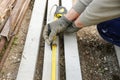 Construction worker measuring concrete pillar