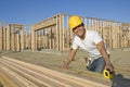 Construction Worker Measuring Planks Royalty Free Stock Photo
