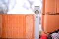 Construction worker measuring with professional level the bricks on walls Royalty Free Stock Photo