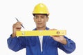 Construction worker measuring with a spirit level Royalty Free Stock Photo