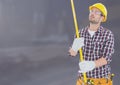 Construction Worker with measuring tape in front of construction site Royalty Free Stock Photo