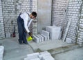Construction worker moisturing concrete foundation with water sprayer Royalty Free Stock Photo