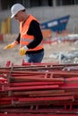 Construction worker mounting scaffolding