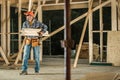 Construction Worker Moving Pieces of Wood Inside Wooden Skeleton Frame of a House Royalty Free Stock Photo