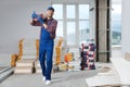 Construction worker with new building materials in room prepared for renovation Royalty Free Stock Photo