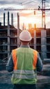 Construction worker observing bustling construction site, symbolizing supervision Royalty Free Stock Photo