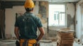 Construction worker observing renovation site, tools visible Royalty Free Stock Photo