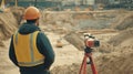Construction Worker Observing Survey Equipment at a Construction Site Royalty Free Stock Photo