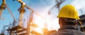 The construction worker observing the vibrant skyline from the job site. AI generated image Royalty Free Stock Photo