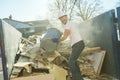 Construction Worker outside of house put old renovation material on big conteiner Royalty Free Stock Photo