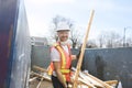 Construction Worker outside of house put old renovation material on big conteiner Royalty Free Stock Photo