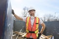 Construction Worker outside of house put old renovation material on big conteiner Royalty Free Stock Photo